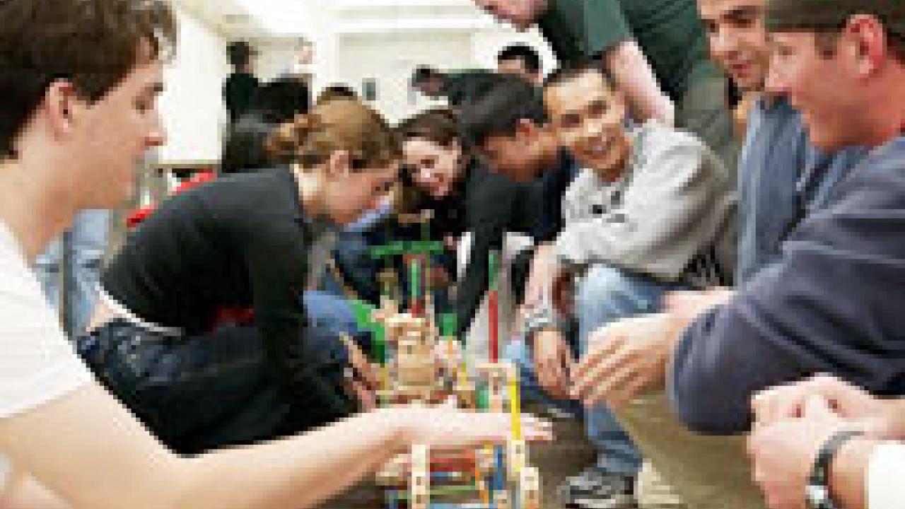 Students enrolled in a contemporary leadership course collaborate on a bridge-building project with help from UC Davis staff member Emily Murdock (not pictured). 