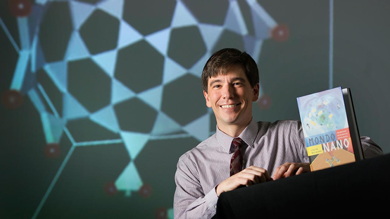 Photo: Colin Milburn, holding his new book, "Mondo Nano: Fun and Games in the World of Digital Matter."