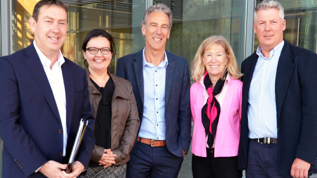 Five people lined up, posed