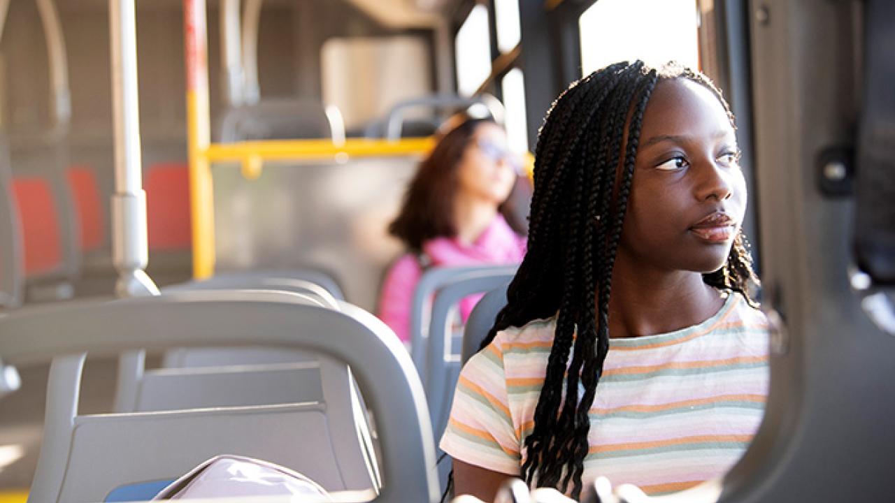 Shelby Dioum looks out the window of a new electric bus