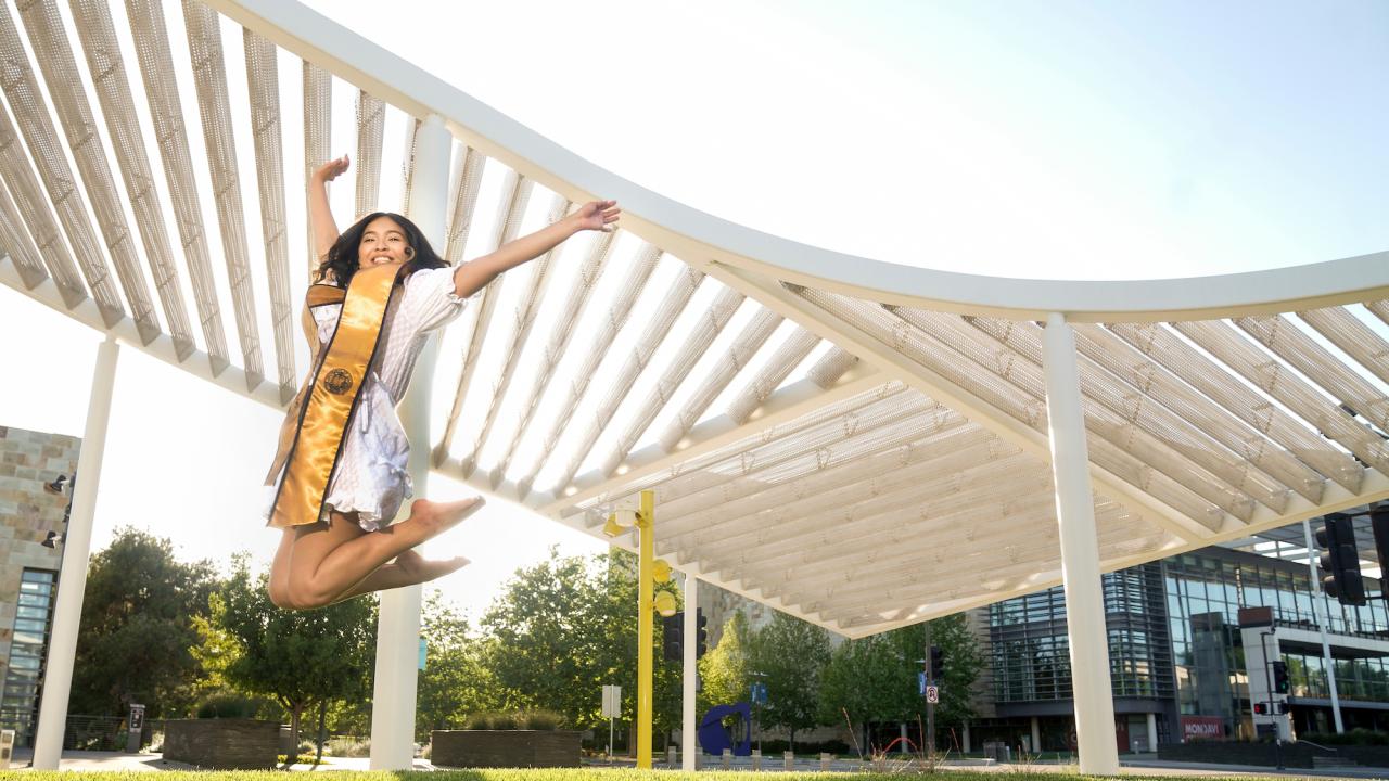 UC Davis Senior and Strategic Communications intern Anisa Luong jumps in front of the Shrem Museum on May 1, 2021.
