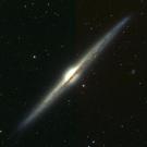 Illustration of galaxy NGC 4565 shows dark lanes of interstellar dust that block sunlight.