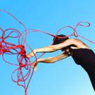 Nina Galin twirls an extension cord, representing institutionalization, in the Main Stage Theatre-Dance Festival's Life Among the Institutions.