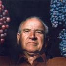 photo: Man holding two bunches of grapes