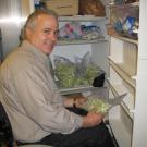 Staff research associate Bill Biasi grabs a bag of apple tissue from a 1978-model freezer, which, if replaced, would bring a rebate.
