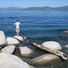 Visitors like this young man, pictured on the Nevada side of Lake Tahoe, saw clear water to an average depth of 69.6 feet last year.