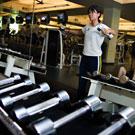 Ahn Thai, on the front, performs capoeira, a Brazilian martial art created by enslaved Africans during the 19th century. She has been practicing capoeira for two years. Martial arts instructor Bob Sarason is in the background wearing black pants
