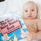 Baby holding "the Best Baby Name Book"