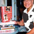 Photo: Man sitting with five books