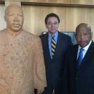 Two men pose with statue of Martin Luther King Jr.