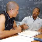 University Medalist Chris Jones, right, tutors freshman football player Brandon Rice in chemistry. His commitments to mentoring, his pre-med studies and hospital work stand among many attributes that distinguish Jones, say coaches and faculty.