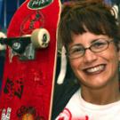 Lisa Girsh shows off the skateboard autographed by NASCAR driver Dale Earnhardt Jr., after he was hospitalized briefly last month at the medical center.  