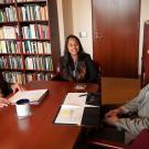 Ralph J. Hexter sits at a table with Namrata Kumar and Kevin Johnson.