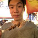 Raymond Lo with fried crickets on a skewer