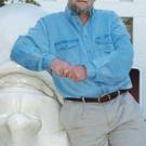 Man shaking woman's hand as a boy in between and another man to the side look on