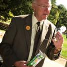 FRONT: Student Angela Capoccia picks out fresh produce from the Vang Farm&rsquo;s stand at the Farmers Market in the East Quad during Sustainability Day. INSIDE: Chancellor Larry Vanderhoef examines the energy efficient light bulbs that were handed 