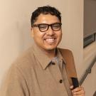 Closeup of Emmanuel Pereida Garcia against classroom wall with stairs in background