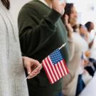 People holding American flags at citizenship ceremony