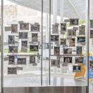 The glass facade and front doors of the Manetti Shrem Museum feature "Sunnyside Up," 