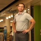 Man stands in hallway with hands on hips