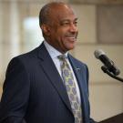 Chancellor Gary S. May speaks at a lectern.