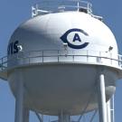 Closeup of newly restored water tower on campus shows Athletics logo