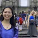 Fionna Huang stands on a crowded street in Hong Kong. 