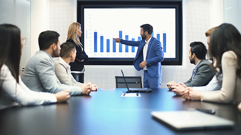 man presenting chart at meeting