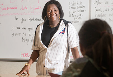 Takarra Johnson in front of white board